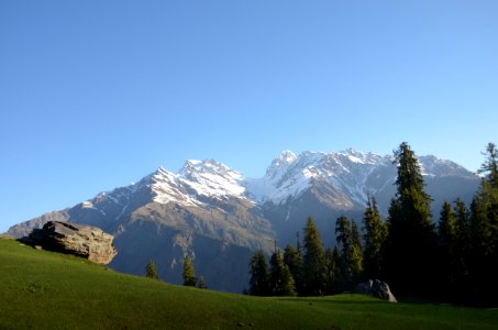 white and green mountain and gray rock near green trees