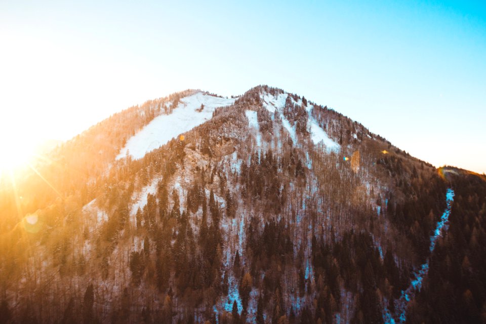 brown and white mountain under blue sky at golden hour