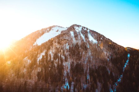 brown and white mountain under blue sky at golden hour photo