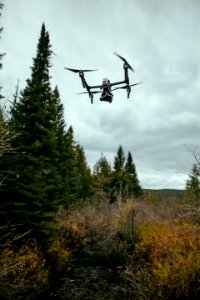 quadcopter drone flying in mid-air during daytime photo