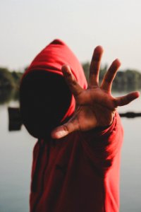 shallow focus photography of person in red hooded jacket photo