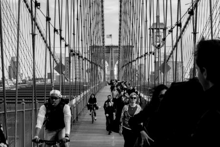 grayscale photo of people on bridge photo