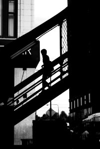 silhouette photo of a person walking down on stair photo