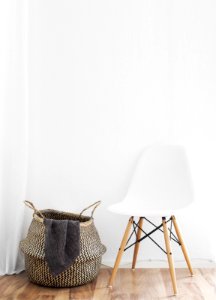 white and brown chairs beside wicker basket near white wall photo