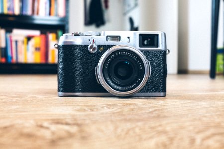 black and gray camera on brwon wooden surface photo