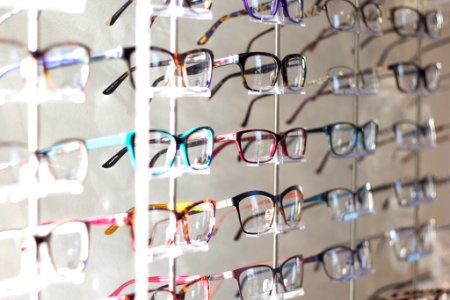 arranged assorted-color eyeglasses on rack photo