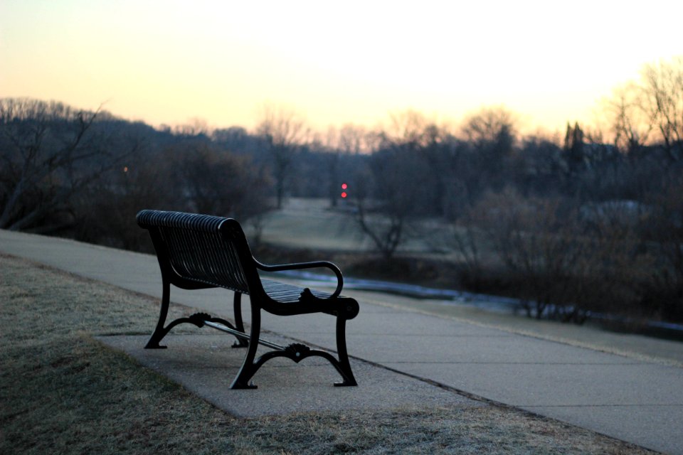 black bench on concrete pavement