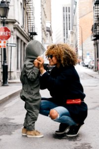 woman holding kid at the street photo