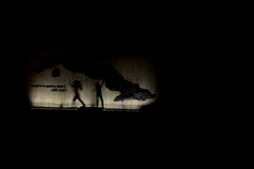 Children playing with their shadows against a wall