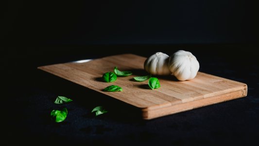 two bulb of garlic on top of chopping board photo