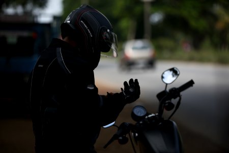 selective focus photo of man wearing motorcycle suit photo