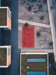red basketball court near buildings in aerial photography photo