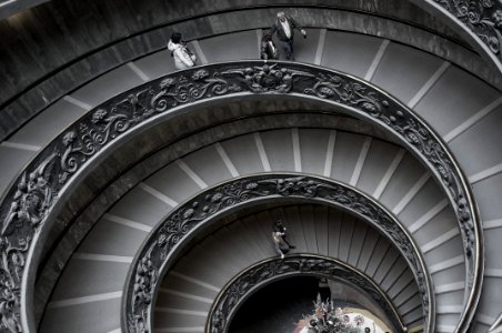people walking on spiral staircase photo