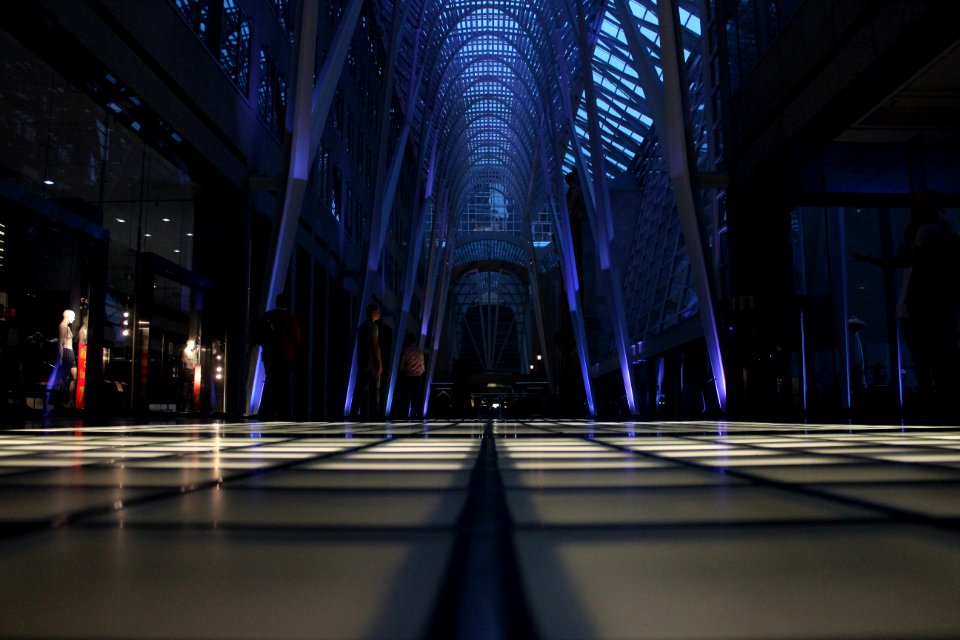 crowd of people inside triangular building interior
