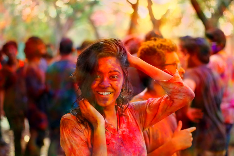 smiling woman holding her head and hair during daytime