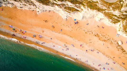 aerial view of people by the beach during daytime photo