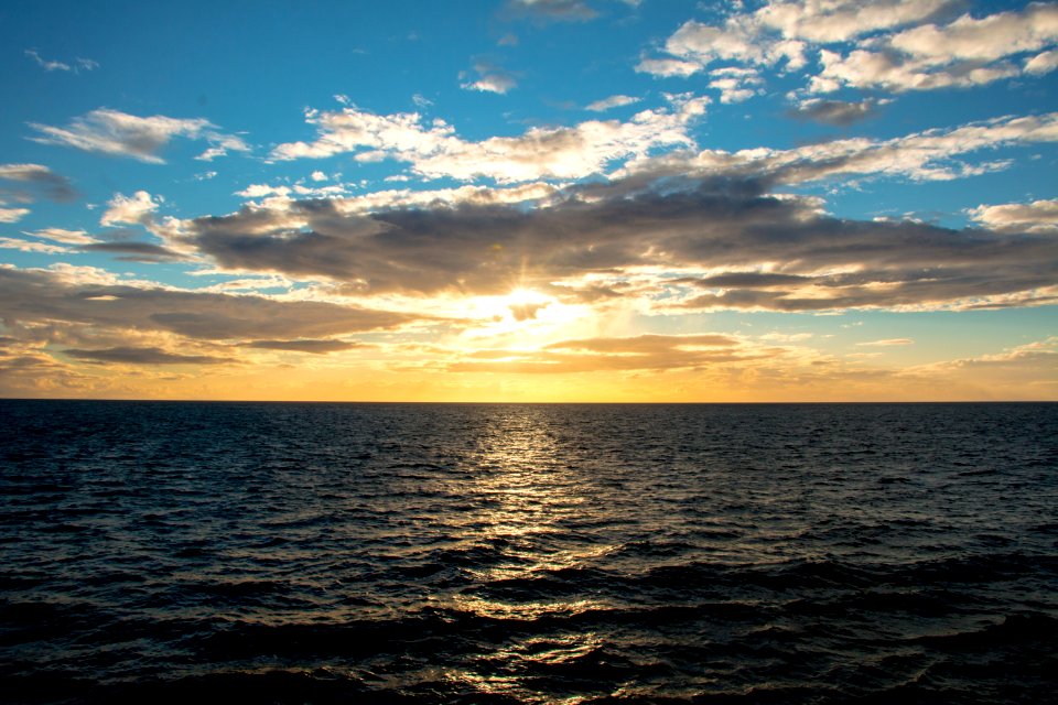 ocean under blue sky at golden houe