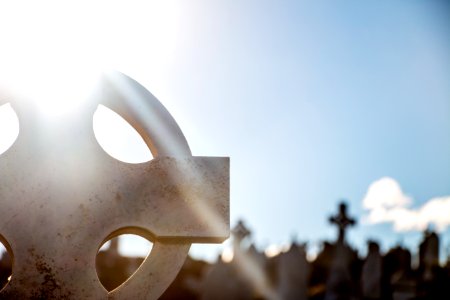 selective focus photography of gray tombstone cross