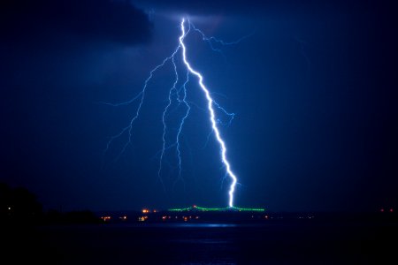 lightning struck on city at night time