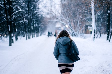 woman walking on street during winter photo