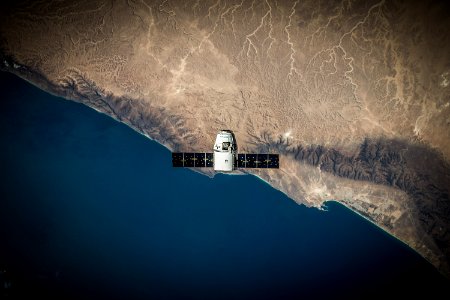 A space satellite hovering above the coastline photo