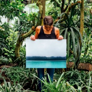 woman holding photo of tidal wave photo