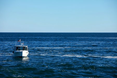 white motorboat at water photo