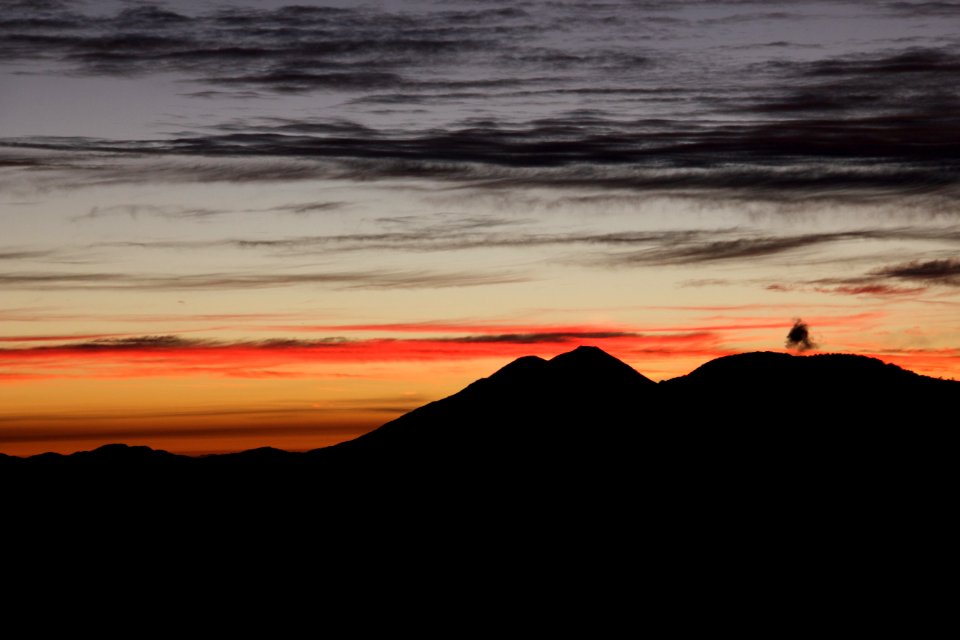silhouette of mountain against sunlight