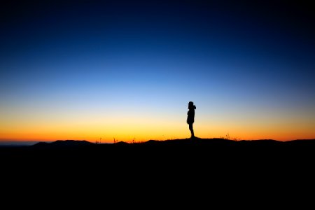 silhouette of a person during sunset photo