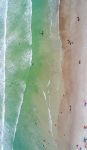 people at the beach during daytime aerial photography photo