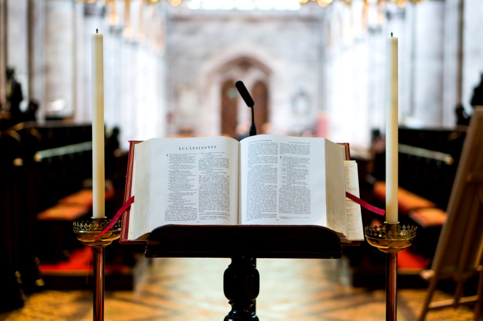 selective focus photography opened Bible on book stand