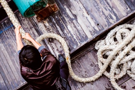 man pulling gray rope photo