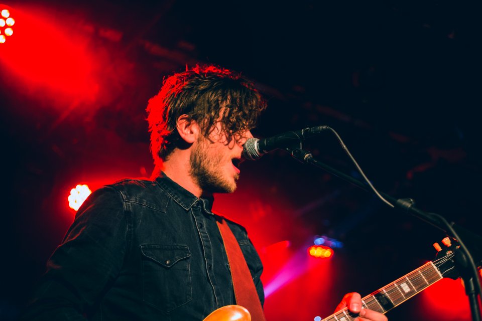 man playing guitar while singing