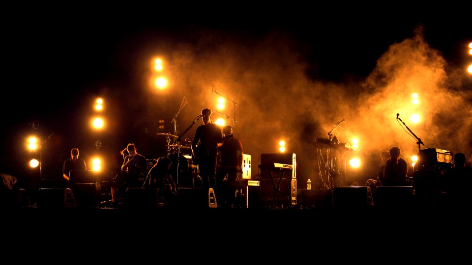 photo of band playing on stage photo