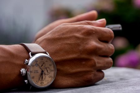 person wearing chronograph watch