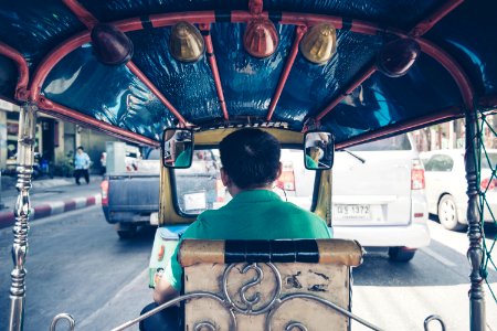 man driving rickshaw photo