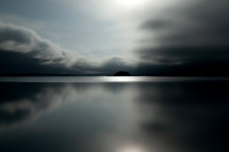 gray clouds reflected on water photo