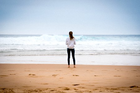 woman standing near seashore during daytime photo