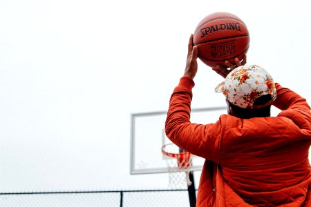 person holding basketball looking at basketball hoop system photo