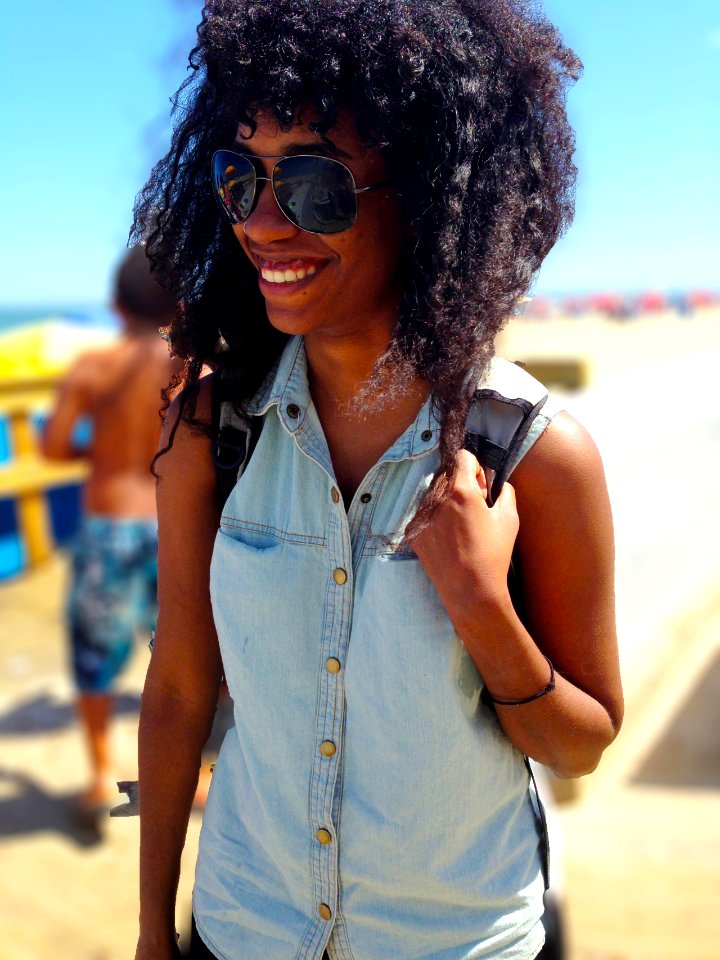 A happy African American backpacking female.