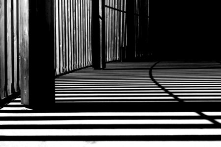 pillar of building shadows grayscale photography