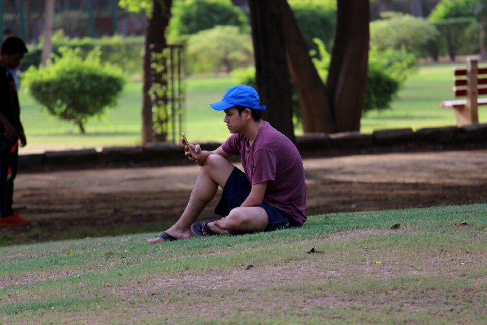 Sitting male relaxing in park