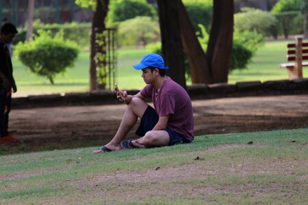 Sitting male relaxing in park