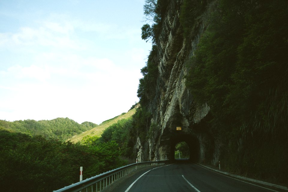 road beside mountain with tunnel photo