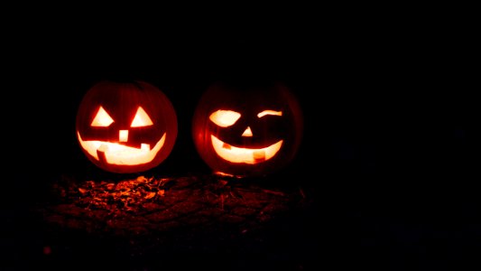 two lighted jack-o-lanterns during night time photo