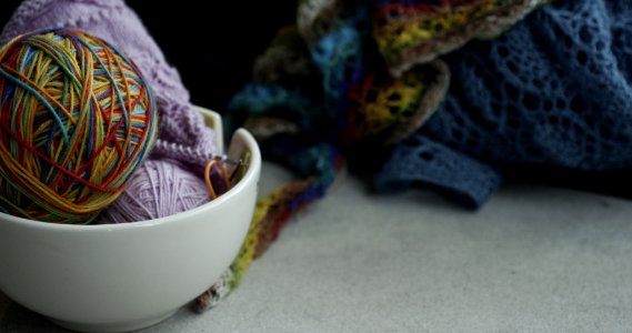 yarn balls on white bowl photo