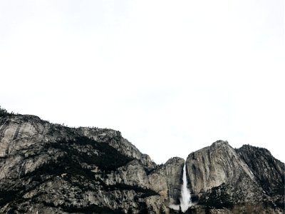 waterfalls under white sky