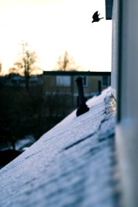 closeup photography of tubular black metal part on roof