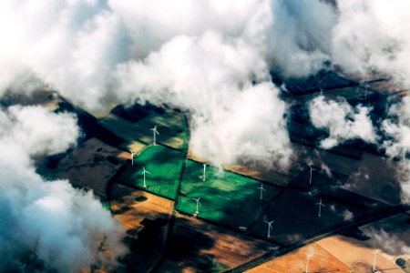 aerial photo of wind turbines near field photo