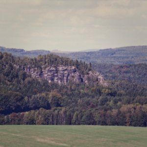 rocky clif near forest range